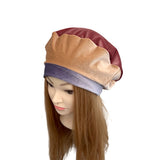 Mannequin head wearing a two-tone headscarf with beige and maroon colors on a white background.