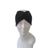 Black headband on a mannequin head against a white background