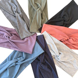 Collection of folded fabric swatches in various colors on a white background