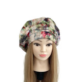 Colorful floral-patterned headscarf on a mannequin head against a white background