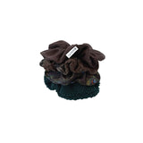 Two brown scrunchies with a brand label on a white background