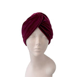Maroon headscarf on a mannequin head against a white background
