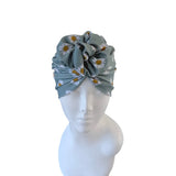 Turban with floral pattern on a mannequin head against a white background