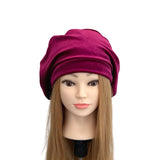 Mannequin head wearing a purple turban on a white background