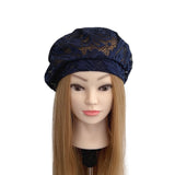 Navy lace headscarf on a mannequin head with long blonde hair against a white background