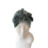 Gray headscarf on a mannequin head against a white background