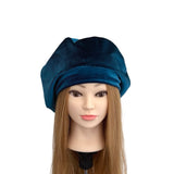 Blue beret on a mannequin head with a white background