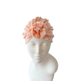 Pink textured headband on a mannequin head against a white background