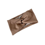 Brown ribbed knit headband on a white background