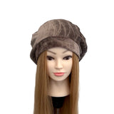 Mannequin head with a brown textured hat on a white background