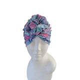 Colorful headscarf on a mannequin head against a white background