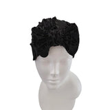 Black headband with ruffled design on a mannequin head against a white background
