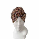 Leopard print headscarf on a mannequin head against a white background