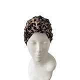 Leopard print headscarf on a mannequin head against a white background