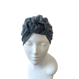 greyish blue patterned headband on a mannequin head against a white background