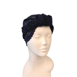 Navy blue headscarf with lace details on a mannequin head against a white background