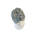 Floral patterned headscarf on a mannequin head against a white background