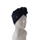 Navy blue lace headband on a mannequin head against a white background