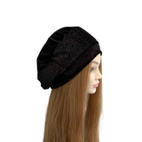 Black beanie on a mannequin head with long brown hair against a white background