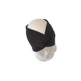 Black knitted headband on a mannequin head against a white background