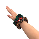 Three scrunchies on a wrist against a white background
