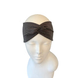 Gray headband on a mannequin head against a white background