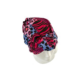 Colorful patterned headscarf on a mannequin head against a white background