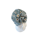 Floral headscarf on a white mannequin head against a white background