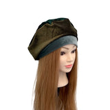 Mannequin head with a brown and gray beret on a white background