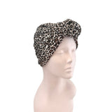 Leopard print headscarf on a mannequin head against a white background
