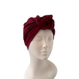 Red headscarf on a mannequin head against a white background