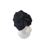 Black headscarf on a mannequin head against a white background