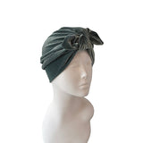Green headscarf with a knot on a mannequin head against a white background