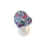 Colorful patterned headscarf on a mannequin head against a white background