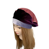 Mannequin head wearing a multicolored headscarf on a white background