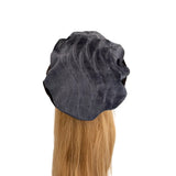 Black hair dryer cap on a mannequin head with blonde hair against a white background