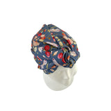 Floral patterned headscarf on a mannequin head against a white background