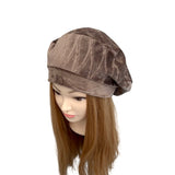 Brown velvet headscarf on a mannequin head with long brown hair against a white background