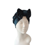 Black textured headband on a mannequin head against a white background