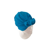 Blue turban on a mannequin head against a white background