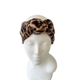 Leopard print headband on a mannequin head against a white background