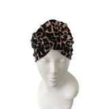 Leopard print headband on a mannequin head against a white background
