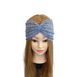 Mannequin head with blue lace headband on a white background
