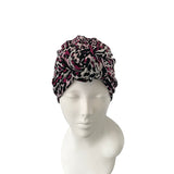 Leopard print headscarf on a mannequin head against a white background