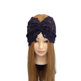 Navy lace headband on a mannequin head with long brown hair against a white background