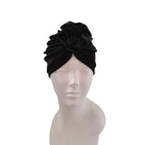 Black velvet turban on a mannequin head against a white background
