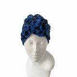 Blue patterned headscarf on a mannequin head against a white background
