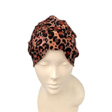 Leopard print headscarf on a mannequin head against a white background