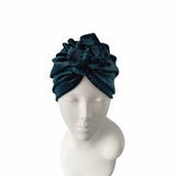 Dark blue headband with floral design on a mannequin head against a white background