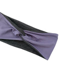 A twisted fabric headband with a smooth lavender-purple outer layer and a textured dark gray inner layer, shown on a plain white background.